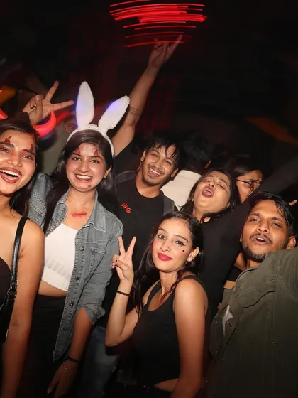 A group of guests in their Halloween costumes, having fun and posing for a photo. The energy was infectious all night.