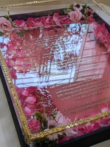 The reflection in this photo shows the glossy, mirror-like finish of the resin on this pink wedding invitation. The details are everything.