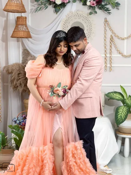 An intimate moment between the couple. The soft colors of their outfits and the boho decor create a warm and romantic scene.