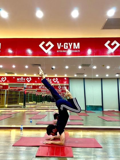 A scorpion variation in a forearm stand, an advanced inversion that requires a deep backbend and precise balance.