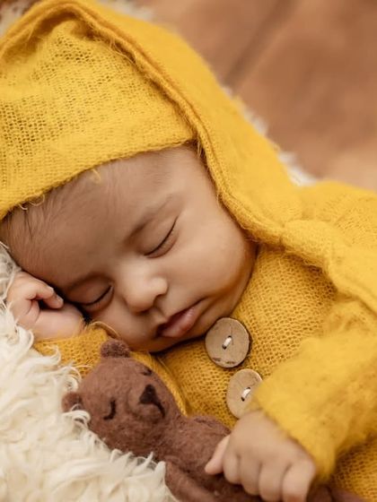 A detailed close-up of the baby's face, showing his peaceful expression as he sleeps.