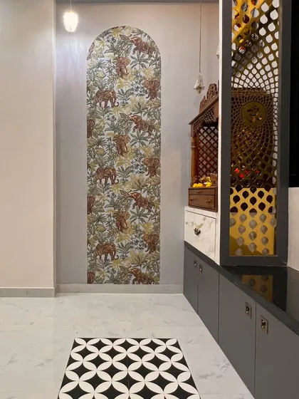 Another angle of the elephant-themed prayer area, highlighting the beautiful floor tiles and the detailed jali work on the cabinet.