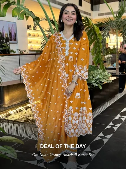 The Nilan Orange Anarkali Kurta Set is a deal of the day. The vibrant orange and intricate white embroidery make it a joyful and festive outfit.