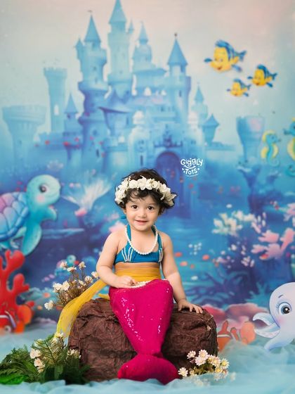 A beautiful little mermaid sits on her rock, ready to greet all the friendly sea creatures in her magical kingdom.