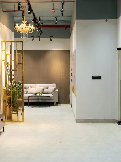 A peek into my Hyderabad Experience Center. This is where you can see and feel the quality of materials firsthand. This space shows a modern living area setup with a sleek sofa and a stylish gold-finished partition.