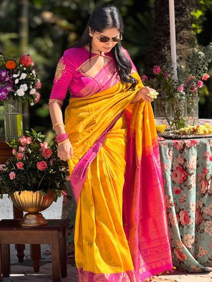 A candid shot of me adjusting my saree. This yellow and pink Kanchivaram is one of my favorites for its vibrant, joyful colors.
