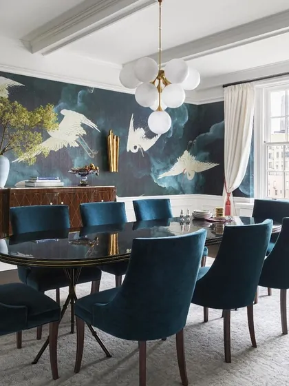 We transform dining rooms into stages for memorable moments. A dramatic, hand-painted mural of soaring cranes sets a tone of artistry and grandeur, complemented by rich velvet dining chairs that ensure every gathering is steeped in comfort and style.