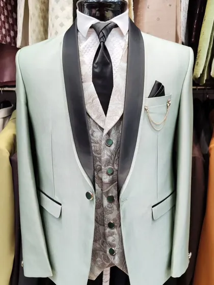 A collection of our designer suits, showcasing a variety of colors, fabrics, and custom details like embroidery, unique lapels, and accessories. Each piece is crafted to make a lasting impression.