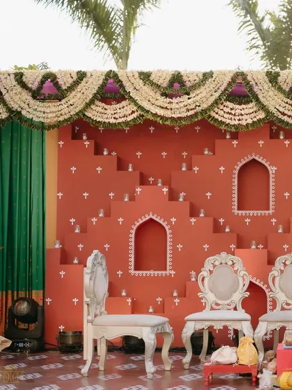 A close-up of the terracotta-colored step-well inspired backdrop for the Haldi. The intricate details and traditional motifs were designed to honor the couple's heritage in a beautiful and artistic way.