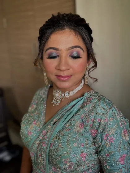 A beautiful smokey eye look for this client. The blend of silver and blue on her lids complements her teal outfit perfectly.