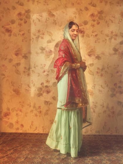 A side profile of Neena Gupta, showcasing the elegant drape of her dupatta.