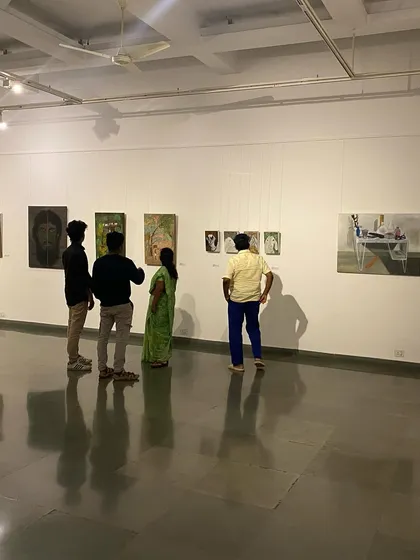 A group of visitors looking at the varied works in the 'ME, AMMA, WE' exhibition.