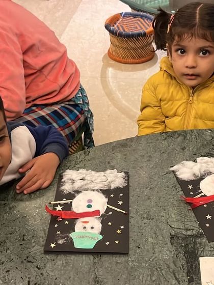 Winter is here! Our rosy-cheeked toddlers are creating adorable snowman cards, a perfect craft for the festive season.