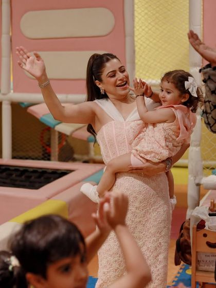 A mother and daughter dance and clap along to the music. Our parties are filled with energy and opportunities for everyone to get involved.