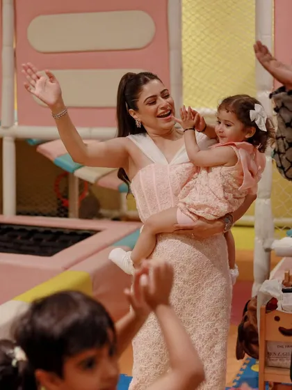 A mother and daughter dance and clap along to the music. Our parties are filled with energy and opportunities for everyone to get involved.