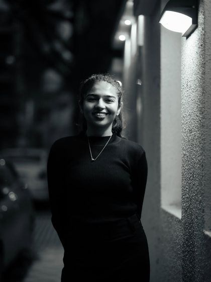 A friendly and approachable black and white portrait. The simple lighting and genuine smile make this a warm and inviting image.