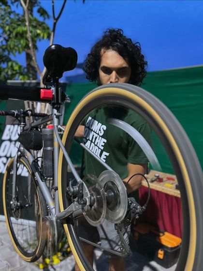 A mechanic from Bums on the Saddle providing technical support at our start line camp during the Turahalli 13 race. We partner with the best to support our community.