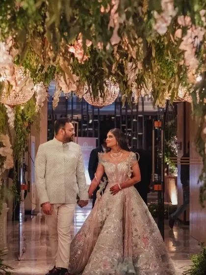 I love bringing fairy tales to life. For this engagement, I designed an enchanted forest entryway with a lush canopy of hanging greenery, white orchids, and sparkling chandeliers, making the couple's entrance truly magical.