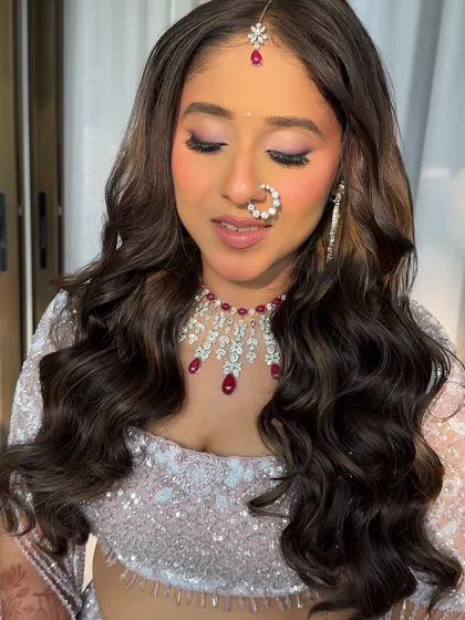 A close-up of the bride's soft makeup and beautiful wavy hair. This look is all about looking fresh, radiant, and effortlessly beautiful on your wedding day.