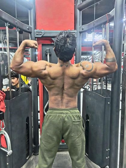 One day to go until the competition. A back double bicep pose showing the peak condition.