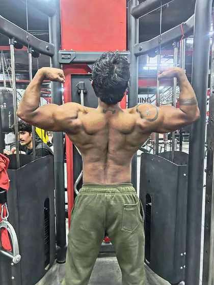One day to go until the competition. A back double bicep pose showing the peak condition.