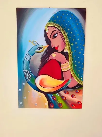 The full view of the woman and peacock painting, hung on a wall to show how it can be a centerpiece of traditional Indian art in your home.