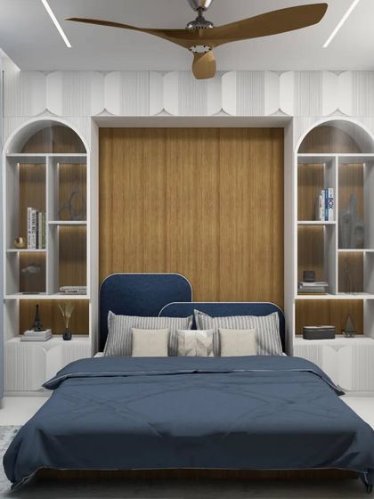 A render of a guest bedroom featuring a smart, space-saving Murphy bed. The design incorporates arched, backlit shelving that frames the bed, providing both storage and a beautiful architectural feature. The deep blue and wood tones create a cozy and inviting feel.