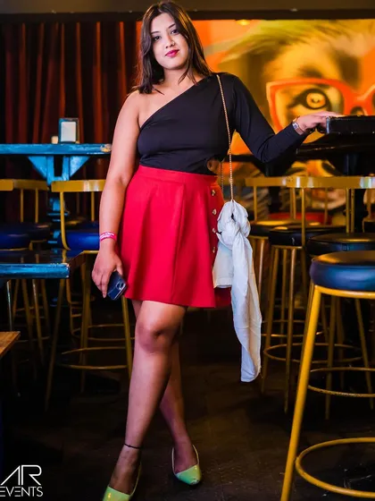 A guest posing in a stylish red skirt.