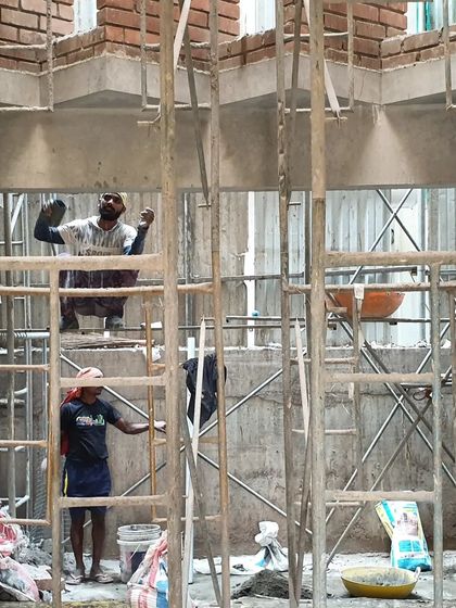 Artisans at work inside the Brick House, framed by scaffolding. This people-driven process is a collaboration where we work hand-in-hand with craftsmen to push the boundaries of materiality.