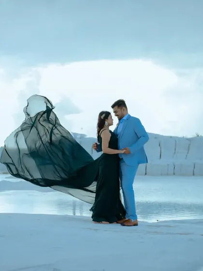 An intimate pose with the dark green gown creating a beautiful, flowing frame around the couple. The soft light and the unique landscape make this a very romantic shot.