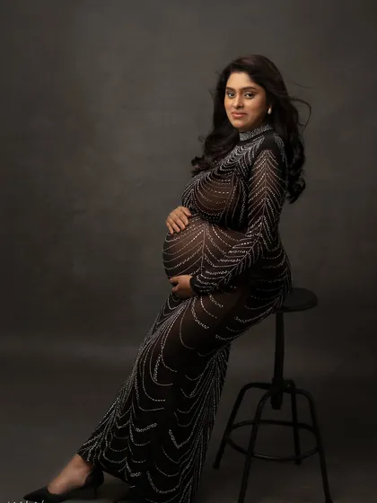 This embellished black gown is a showstopper. The way it catches the light highlights the bump in such a unique and glamorous way.