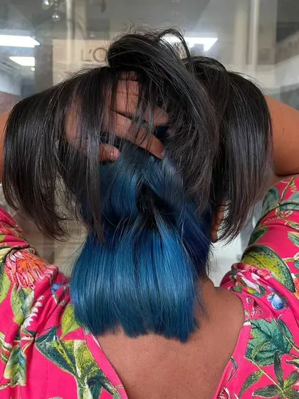 Peekaboo color is a modern and playful way to wear fashion shades. Here, I've applied a vibrant blue to the underlayer of the hair, which reveals itself with movement. It’s a great way to experiment with color without a full-head commitment.