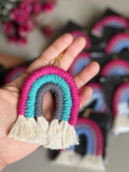A bright and fun rainbow keychain with pink, grey, and teal.