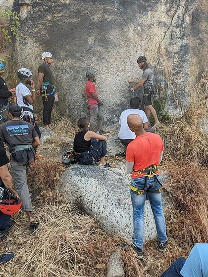 Participants in a PCGI course learning technical skills at the crag. Continuous education is key to being a responsible and competent climber.