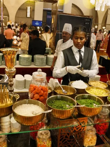 My live Khao Suey counter allows guests to build their own perfect bowl. I provide a rich, coconut-based Burmese curry with a wide array of toppings like fried noodles, onions, and herbs for a customized meal.