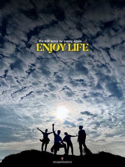 A silhouette of friends against a dramatic sky. We will never be this young again, so let's enjoy life.