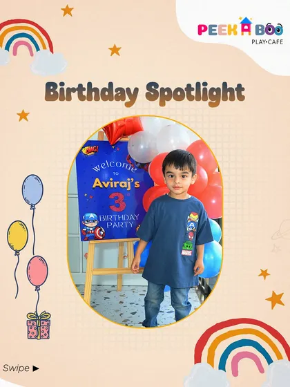The birthday boy, Aviraj, standing proudly in front of his superhero-themed welcome sign. It's all about making them the star of the show.