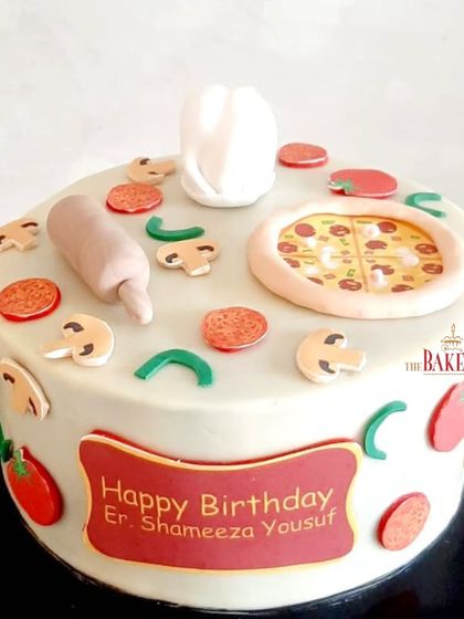 A fun cake for a pizza fan! This minimal-fondant cake is decorated with edible pizza slices, mushrooms, pepperoni, and even a tiny chef's hat and rolling pin.
