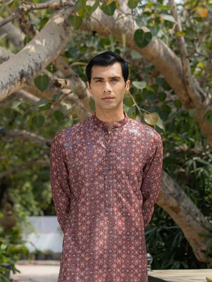 This printed kurta by Rabani and Rakha features a dense, intricate pattern in a deep maroon. It is a rich and elegant choice for any formal celebration.