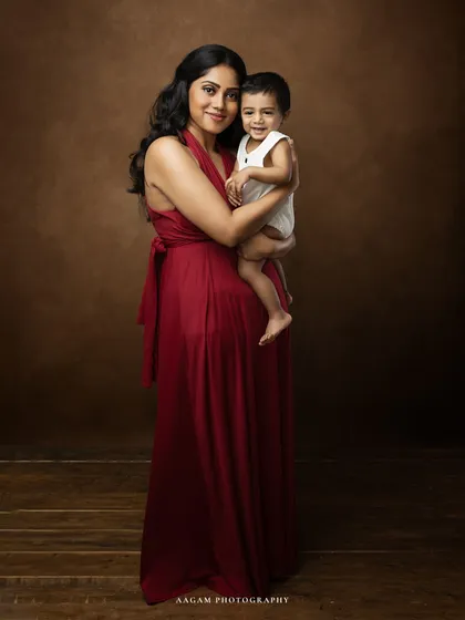 The purest joy is found in a mother's arms. This portrait celebrates that simple, powerful connection, preserving the warmth and laughter of this precious time in your family's life.