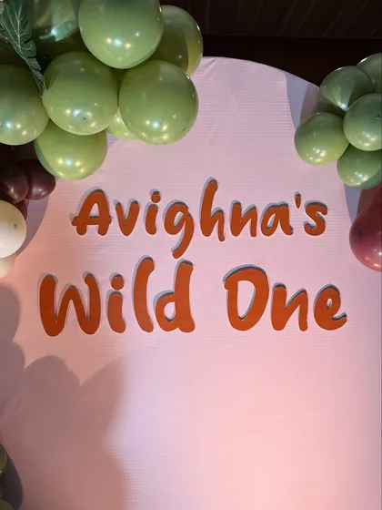 The custom 'Avighna's Wild One' sign for a first birthday party. We create personalized signage that perfectly matches the font and color scheme of your chosen theme.