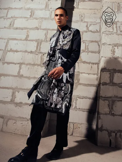 The Mythic Tapestry kurta, sculpted in noir and layered with symbolism. This piece is tailored for the modern man who appreciates a story woven into his wardrobe.