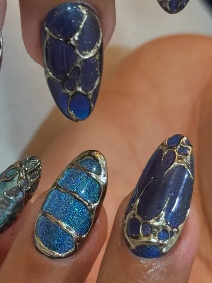 A macro shot showing the intricate gold work and the depth of the cat-eye polish.