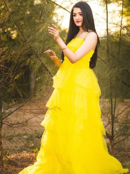 The movement and light texture of the yellow tulle gown are captured in this shot. It's an excellent rental option for creating a fresh and vibrant look for a portfolio.