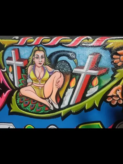 Another detail from the Iron & Gold sign, depicting a woman with a peacock and crosses.