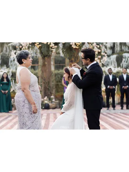 A father gently places the veil on his daughter's head, a tender and symbolic gesture. I focus on capturing these quiet acts of love between family members.