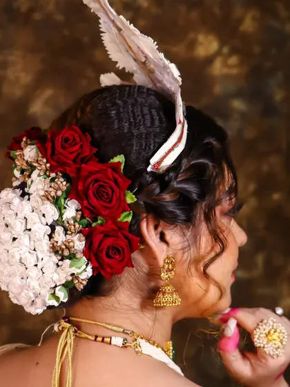 A full view of the intricate floral bun we created for this Bengali bride. The combination of red and white flowers is a timeless choice.