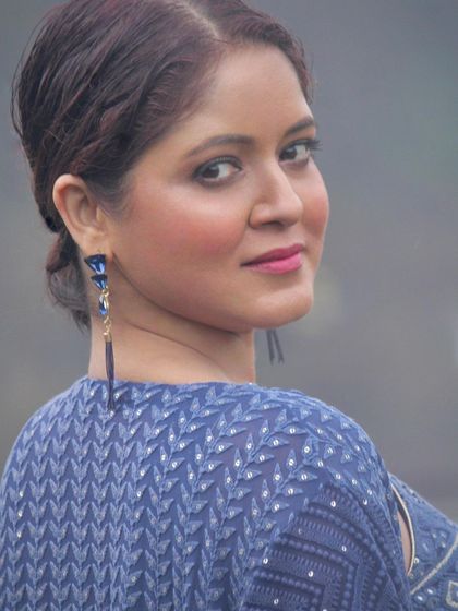 A beautiful close-up shot of the model, with the focus on her expression and the outfit's color.