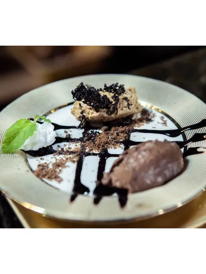A decadent hazelnut platter, featuring different textures of chocolate and hazelnut mousse, artfully arranged on a golden plate. Desserts are the fairy tale of my kitchen.
