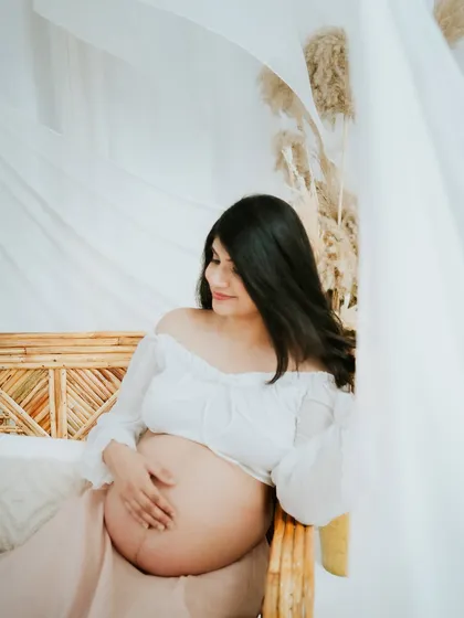 Embracing the serene and dreamy side of motherhood. This studio session uses soft lighting and flowing fabrics to create a calm, beautiful portrait that focuses on the peaceful anticipation of meeting your little one.